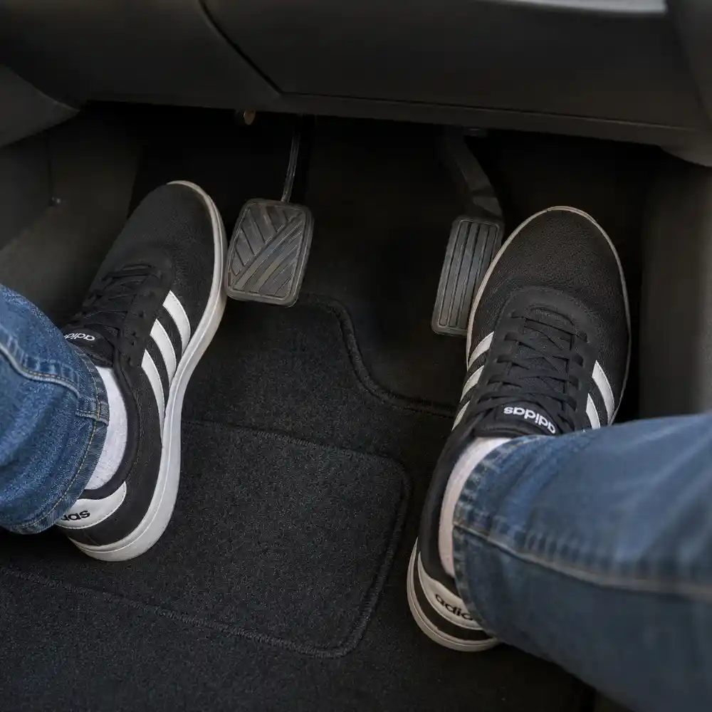 Student feet on brake and accelerator pedals during a driving lesson at The Dreamial Driving School Model Town Lahore.
